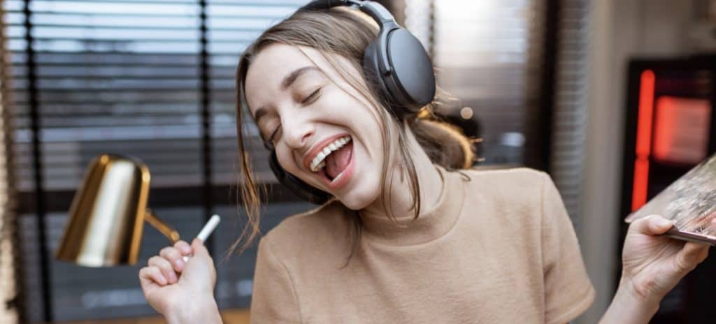 Woman in Headphones Enjoying Music in Home Studio